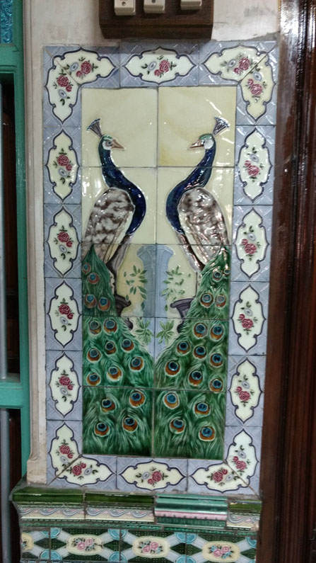 Peacock tile design next to the main door