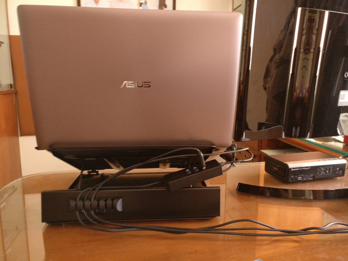 The rear side view of the laptop and the laptop stand