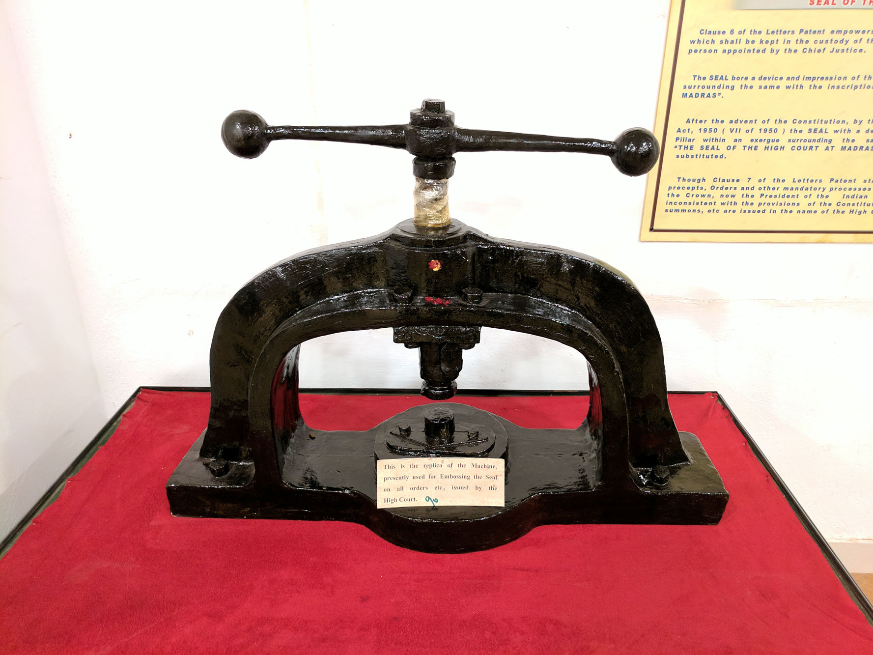 Replica of the machine, used for embossing the seal on all orders issued by the High Court