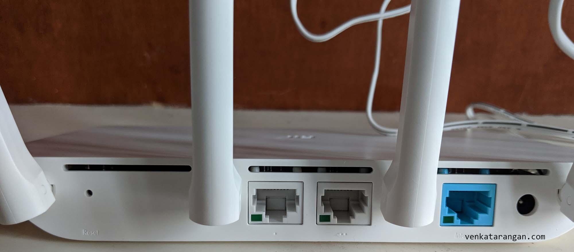 (view from behind) Xiaomi Router 3C has two Ethernet LAN ports (White) and one Internet WAN port (Blue)
