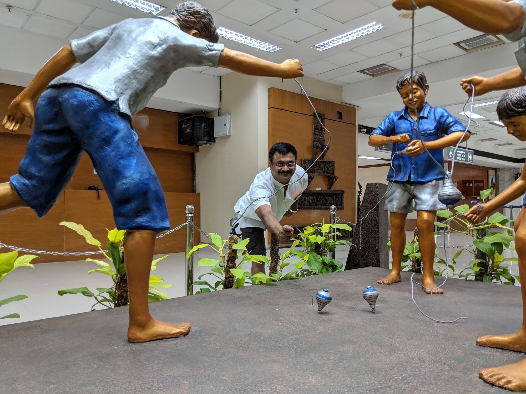 Venkatarangan playing Spinning top (பம்பரம்) with the boys.