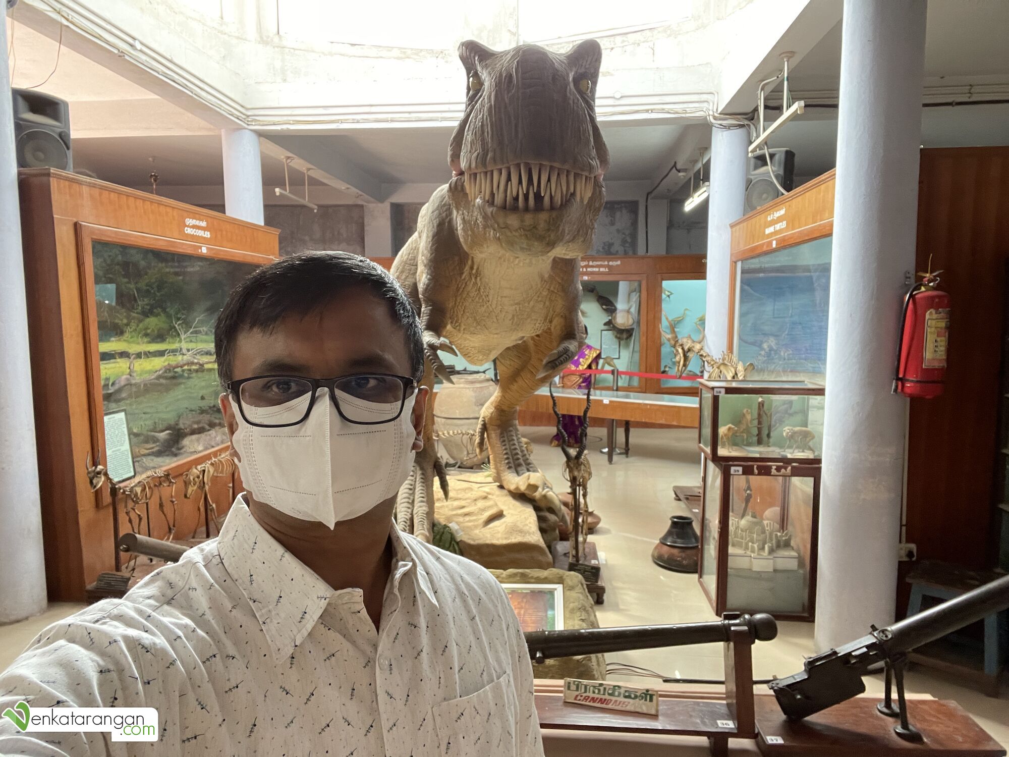 Venkatarangan in front of a Dinosaur display