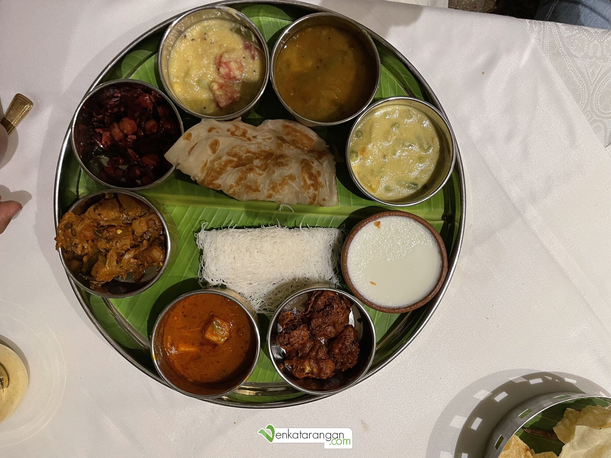 Vegetarian main course – Kerala Parotta, Idiyappam, followed by coconut rice and white rice, accompanied with Sambar, Rasam, Currys and Cauliflower pakkoda