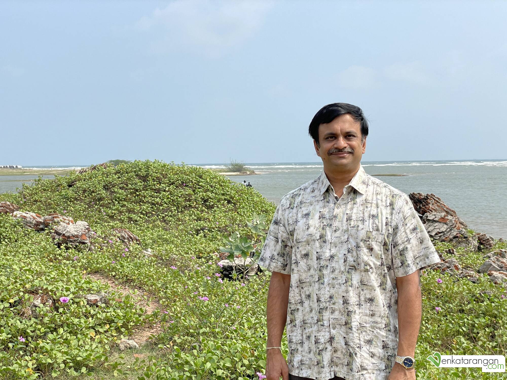 Venkatarangan posing for a picture with the backwaters behind me