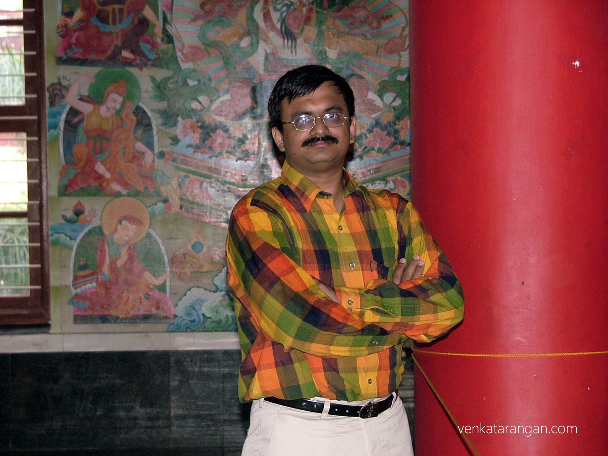 Behind me are tales from the life of Lord Buddha - Namdroling Monastery
