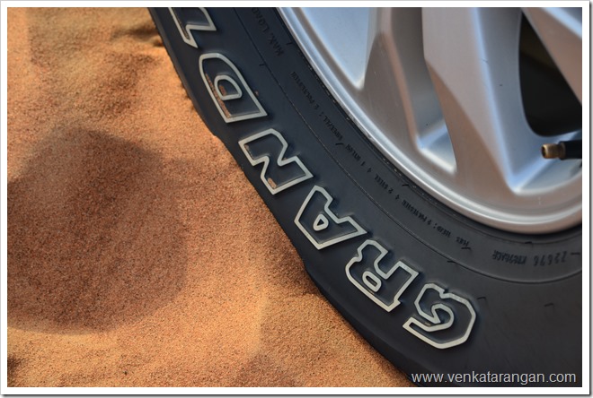 Wheel of Land Cruiser in Sands of Dubai Desert Safari Wheel of Land Cruiser in Sands of Dubai Desert Safari