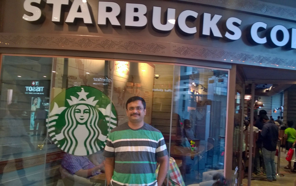 Venkatarangan in front of the first Starbucks in Chennai in 2014