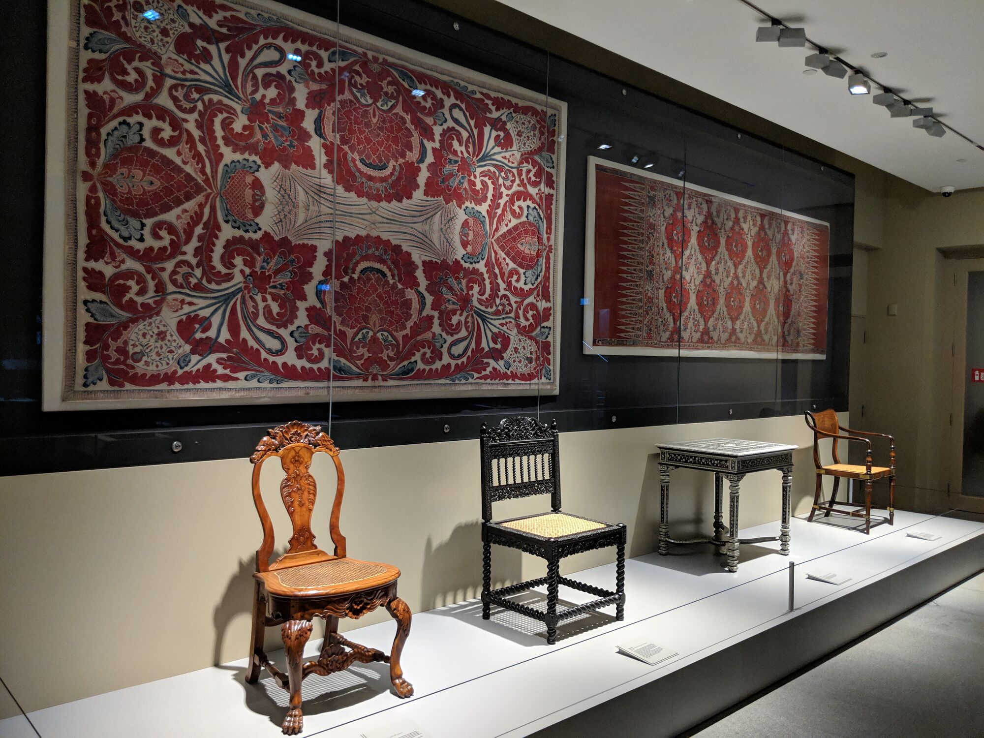 1) Raffles chair, Java or Kolkata around 1810s. 2) Table, India, Vizagapatam, intricately inlaid with ivory. 3) Side chair, India, Coromandel Coast, late 17th century, Ebony wood. 4) Cotton Textiles - Hanging with the tree of life, 17th or 18th century. 