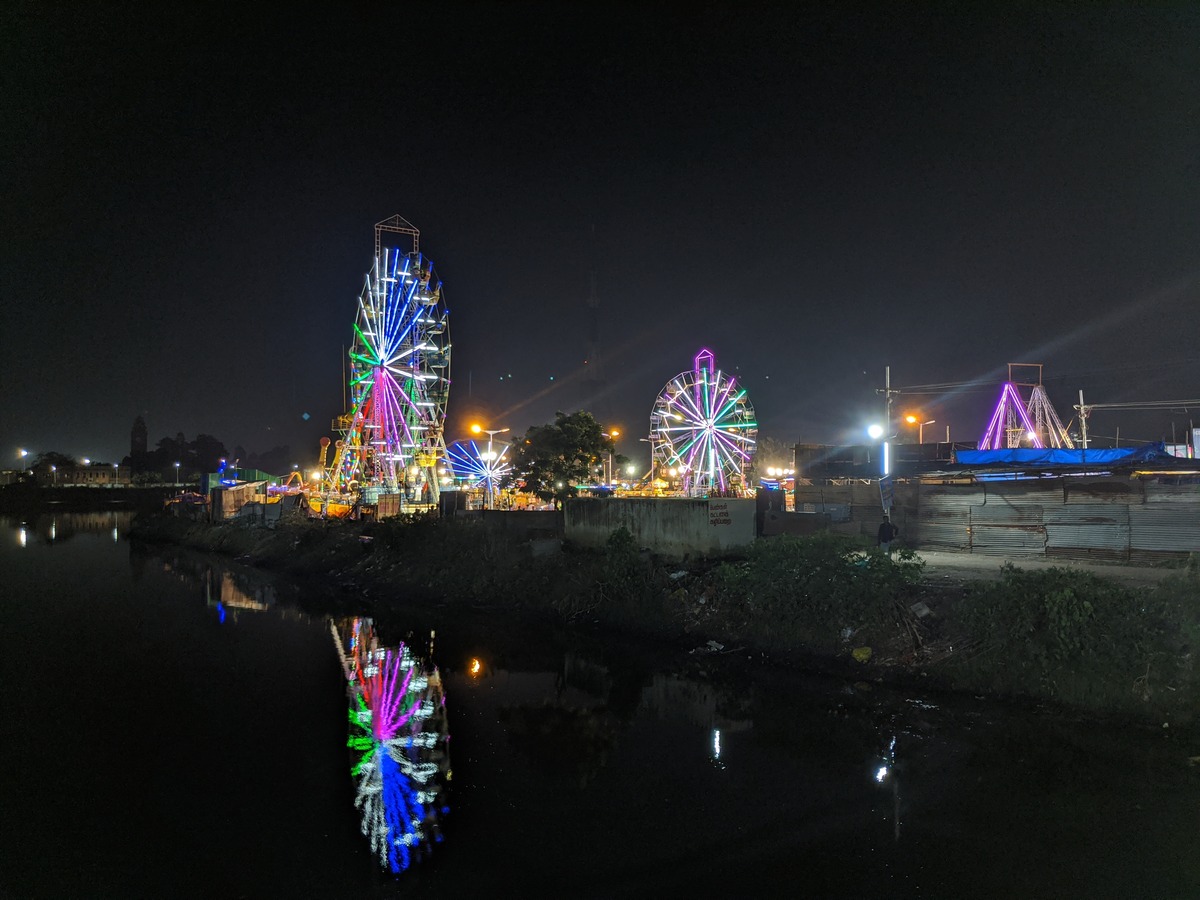 Night view across River Cooum of the rides like the Giant wheel
