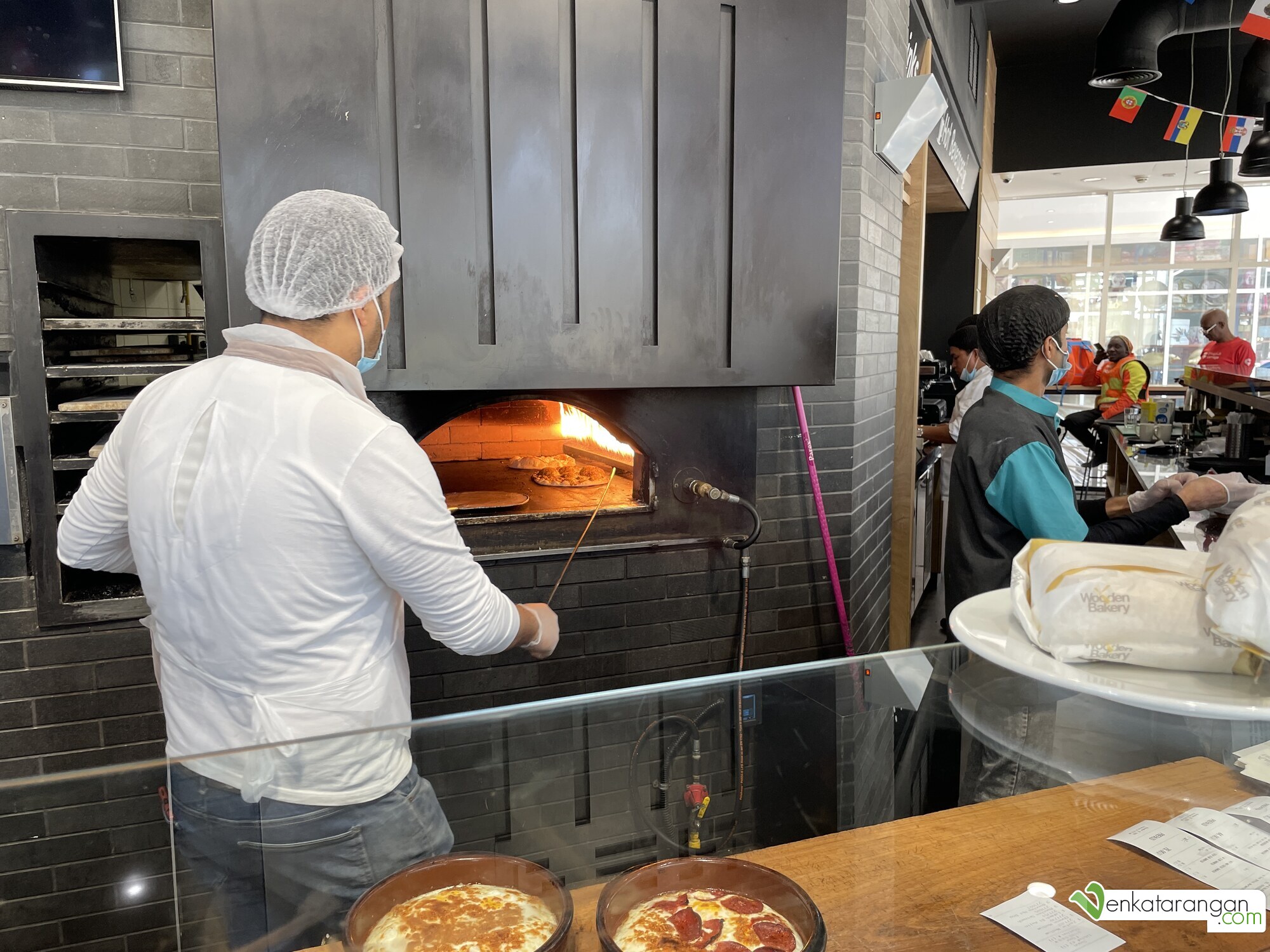 Fresh Pizza being made in an oven at the Wooden Bakery, Doha Souq Mall